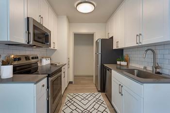 A kitchen with a sink and a refrigerator 